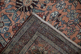 Vintage Mehreban rug corner, dusty copper floral pattern, intact side selvage, hand-knotted back.