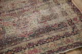 Antique Kerman rug's intricate floral border and thousand flower field in softened ivory and red.