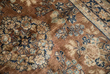 Vintage Sarouk rug detail: chestnut field, navy, beige, dusty blue floral palmettes.
