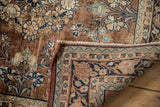 Sarouk rug's curvilinear and geometric border, showing red cord selvage and woven foundation.