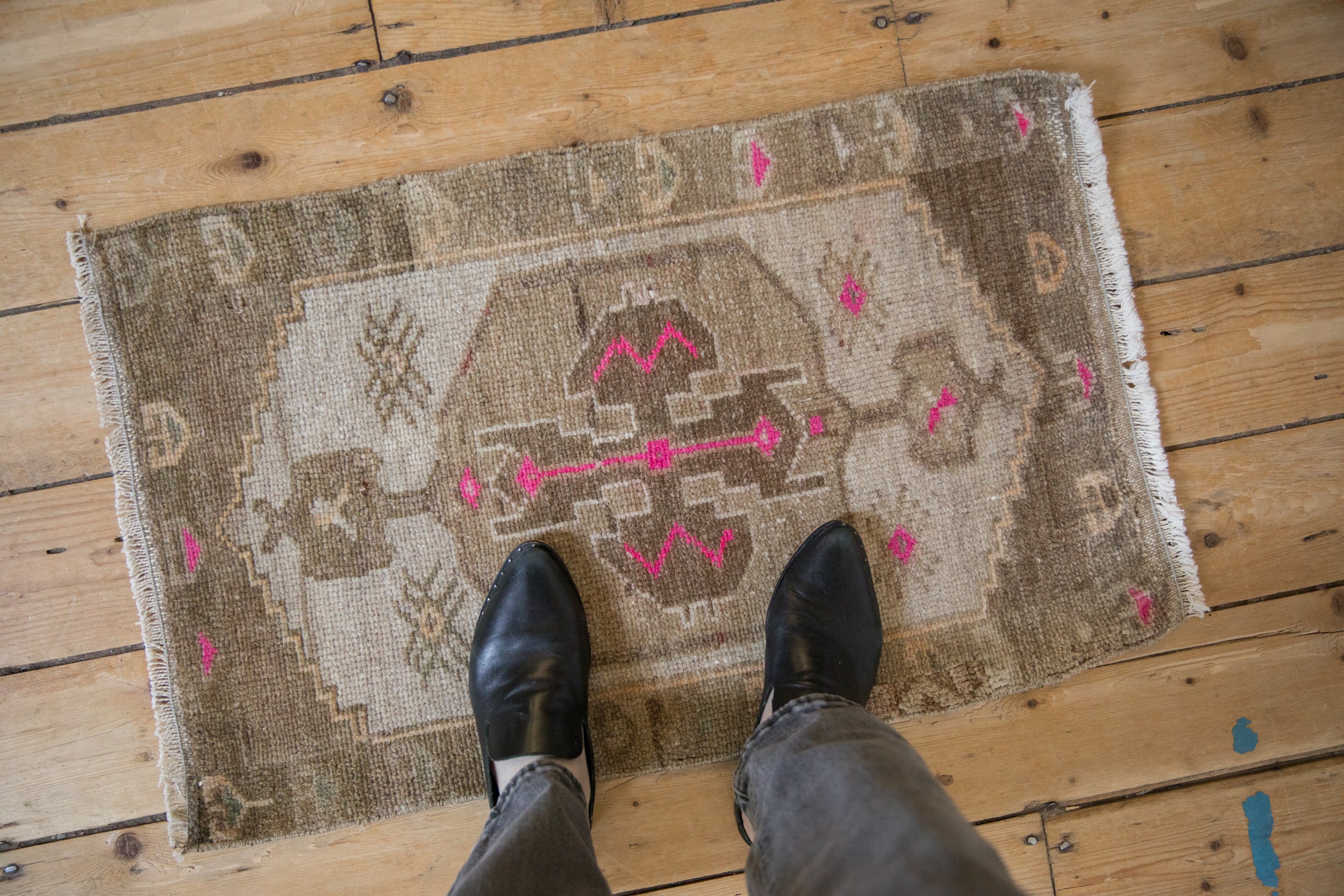 Vintage Distressed Kars rug mat showing faded neutral tones with bright magenta accents.