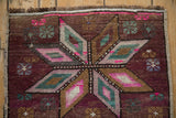 Distressed Turkish Kars rug, machine-bound edge, short fringe, worn aubergine, magenta, teal pattern.