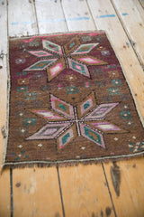 Distressed Kars rug, geometric starburst pattern with magenta, teal, and ivory accents.