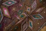 Distressed Kars rug pile texture: purple, teal, brown geometric diamonds, visible knot heads.