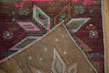 Textured pile, machine-bound edge, and woven foundation of the distressed Kars rug.