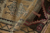 Textured pile of vintage Kars rug with geometric magenta and muted green border.