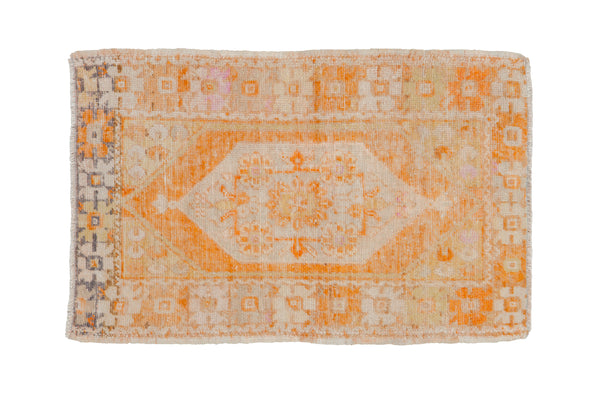 Distressed vintage Oushak rug with tangerine orange, ivory, and charcoal geometric medallion.