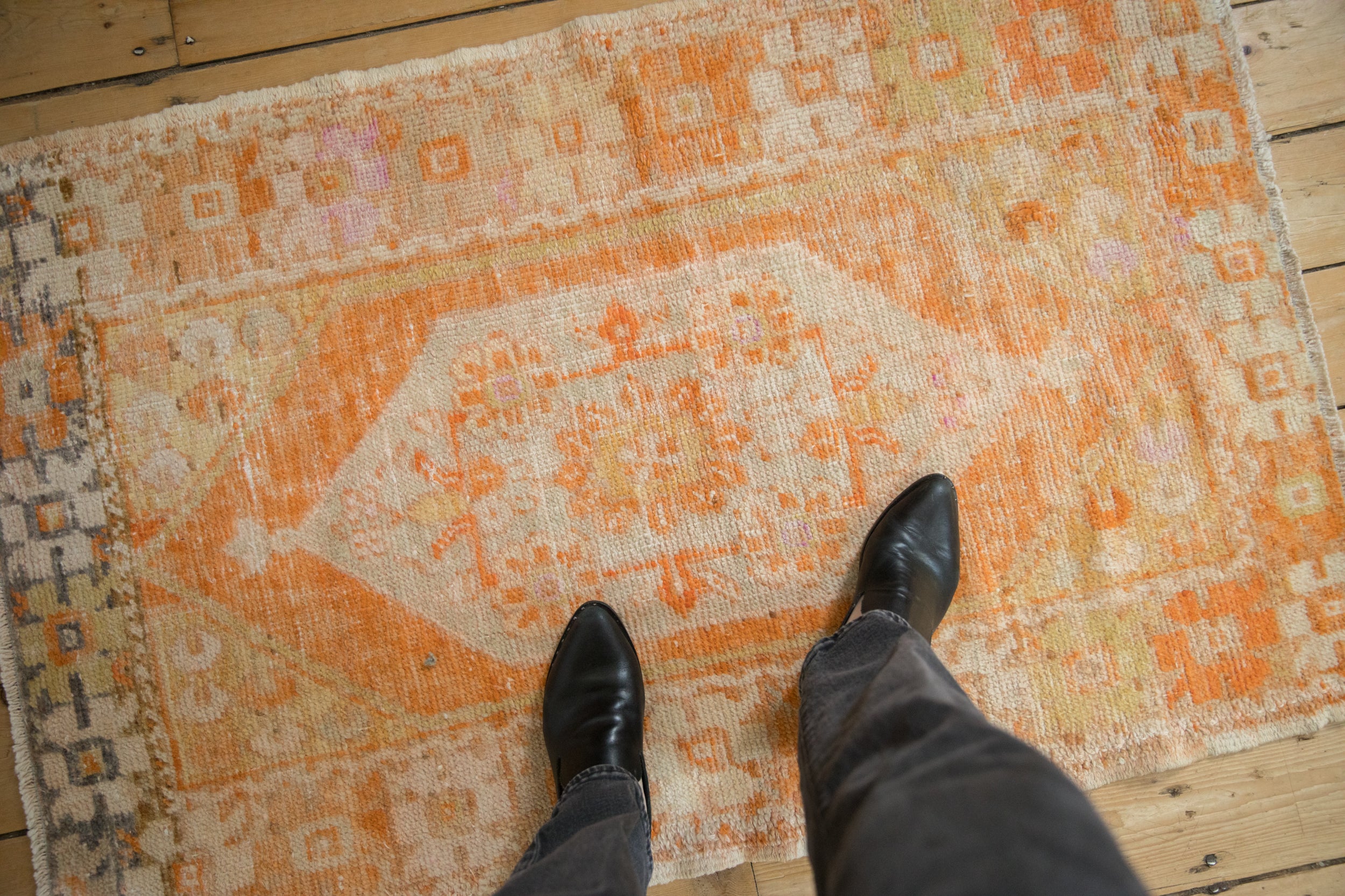 Vintage distressed Oushak rug with vibrant tangerine orange and ivory worn texture.