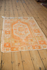 Distressed vintage Oushak rug featuring vibrant tangerine hues and ivory geometric motifs.