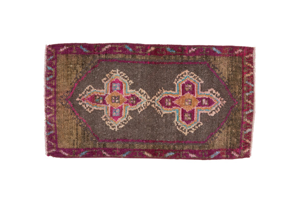 Vintage distressed Kars rug mat with double quatrefoil medallions in purple, charcoal, and blush.