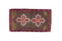 Vintage distressed Kars rug mat with double quatrefoil medallions in purple, charcoal, and blush.