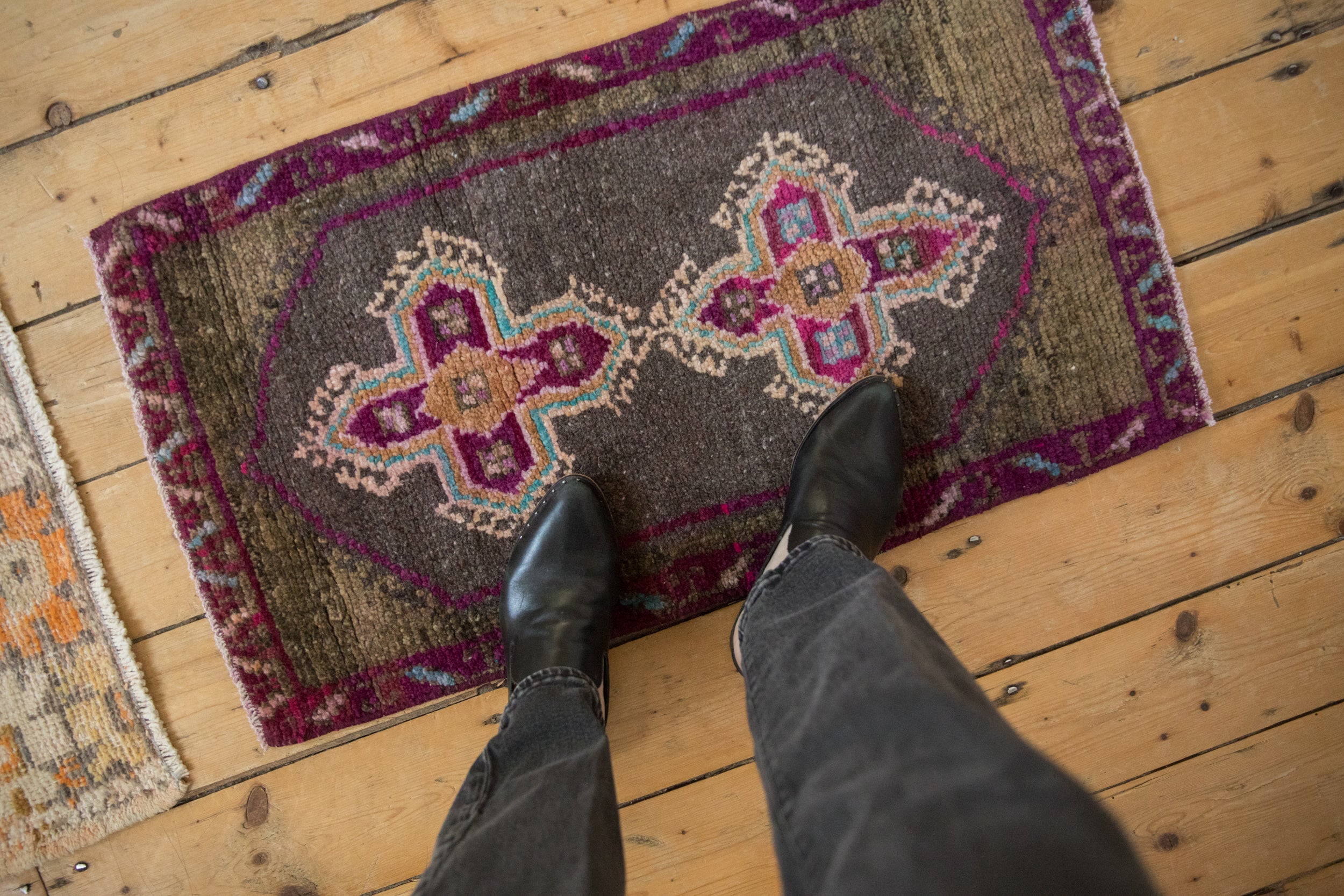 Distressed Kars rug's short pile, revealing purple, royal blue, and ivory quatrefoil motifs.
