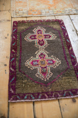 Textured purple and blush quatrefoil medallion with teal accents on a distressed Kars rug.