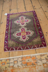 Vintage Kars rug with short, distressed pile in faded purple and charcoal.