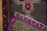 Distressed Turkish Kars rug's vibrant purple pile texture and hand knotted reverse.