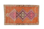 Vintage Distressed Kars rug with triple geometric medallions in terra cotta, fuchsia, beige.