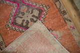 Distressed Kars rug's folded corner reveals worn pile, foundation, and machine-bound edge.