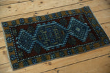 Distressed texture and geometric blossom border of a vintage Kars rug.