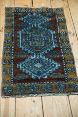 Distressed Kars rug: central medallion and hook-and-latch motif in cobalt blue, ochre.