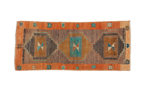 Distressed vintage Kars runner rug with triple medallions, terra cotta border, and turquoise accents.