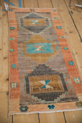Distressed Turkish Kars runner shows stepped relief, bronze, terra cotta, turquoise colors.