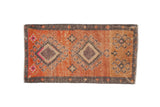 Distressed vintage Kars rug with central double hook medallions, terra cotta, mauve, grey.