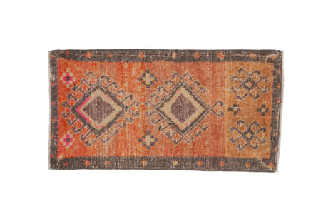 Distressed vintage Kars rug with central double hook medallions, terra cotta, mauve, grey.