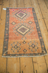Distressed vintage Kars rug's texture, showing geometric medallions and soft, worn pile.