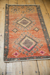 Distressed vintage Kars rug: double hook medallion, abrashed field, sandalwood, magenta, and aubergine.