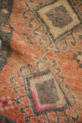 Vintage Kars rug's distressed pile texture, revealing geometric patterns and fuchsia.