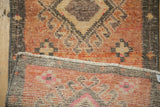 Distressed sandalwood and terra cotta pile with hand-knotted reverse of a Vintage Kars rug.