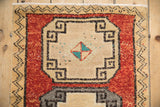 Distressed Kars rug with cream geometric medallion, turquoise pinwheel, and brick red field.