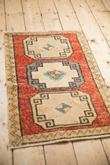 Distressed Turkish Kars rug close-up: brick red field, lightning contour border, geometric medallion.