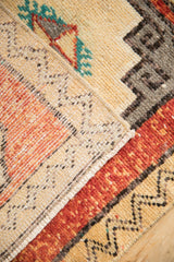 Distressed Kars rug texture; brick red, cream, and brown geometric patterns; machine-bound side.