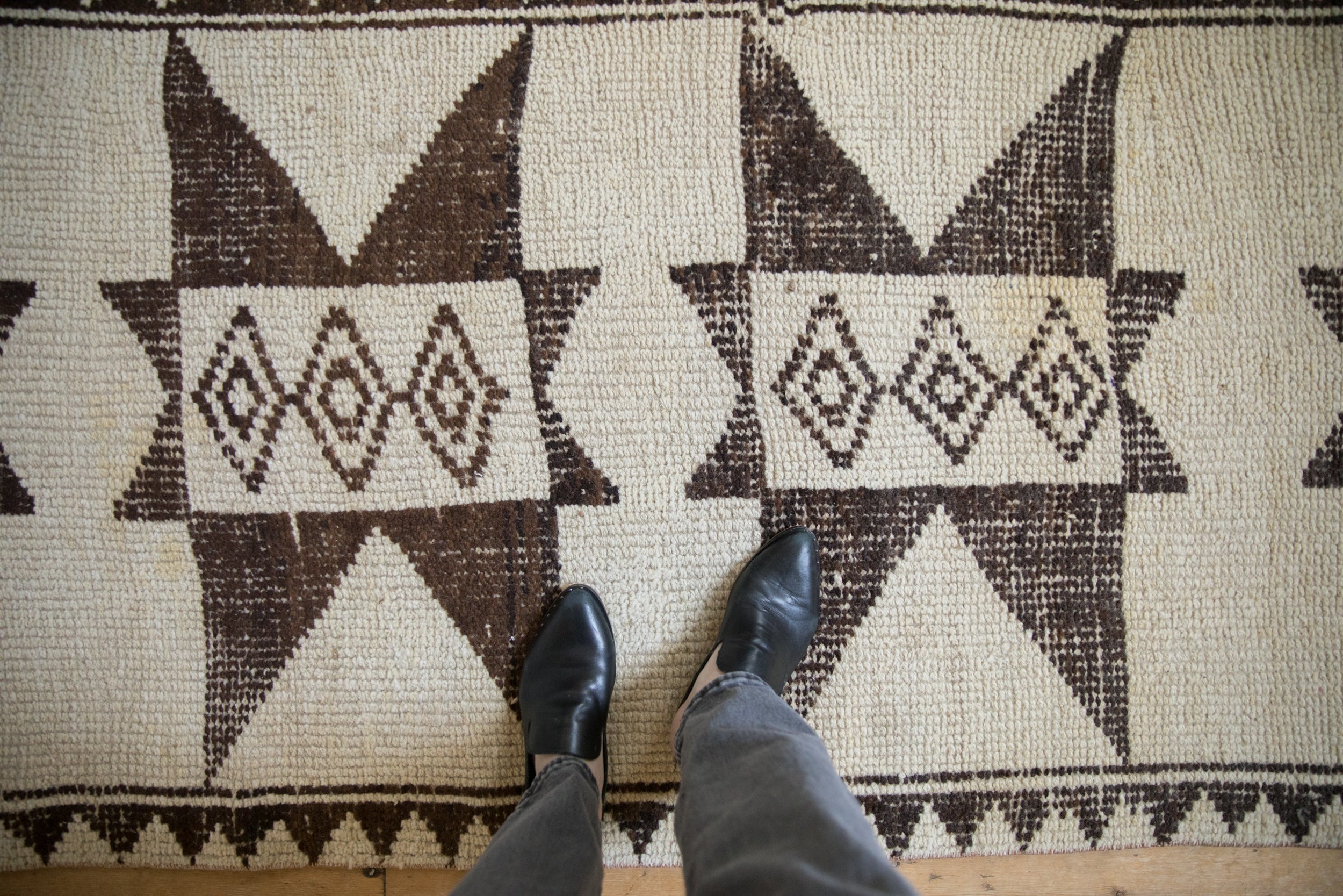 Textured distressed Kurd runner pile with primitive ivory and chocolate brown starburst medallions.