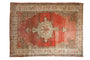 Distressed vintage Oushak carpet with central medallion, abrashed red field, 7' x 9'4".