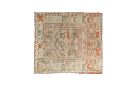 Distressed Vintage Oushak square rug featuring an oversized stepped medallion, finned blossoms, and primitive geometric border in soft ivory, dusty pink, and olive tones.