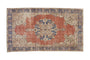 Distressed terra cotta Sparta carpet with cobalt blue medallion and ivory floral spandrels.