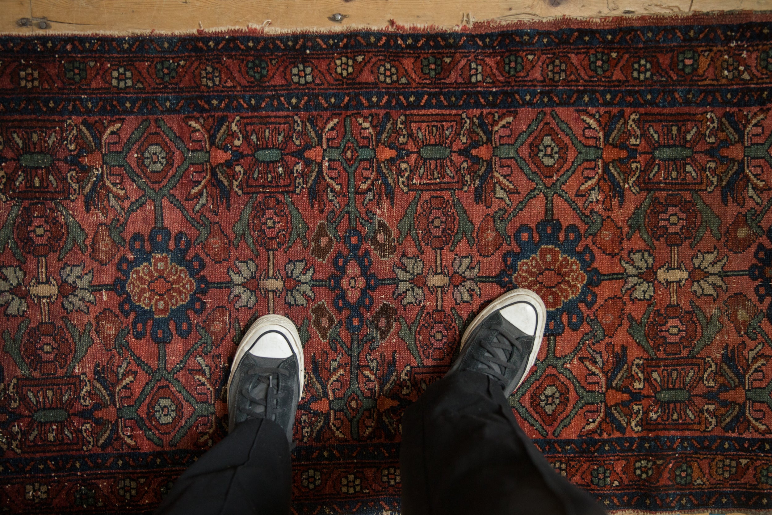 Detailed pattern of Vintage Lilihan rug with raspberry red field, sapphire blue medallions, and floral arabesques.