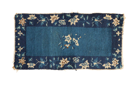 Antique Chinese Peking rug with cobalt field, central floral burst, navy lotus-butterfly border. 1'5"x2'9".