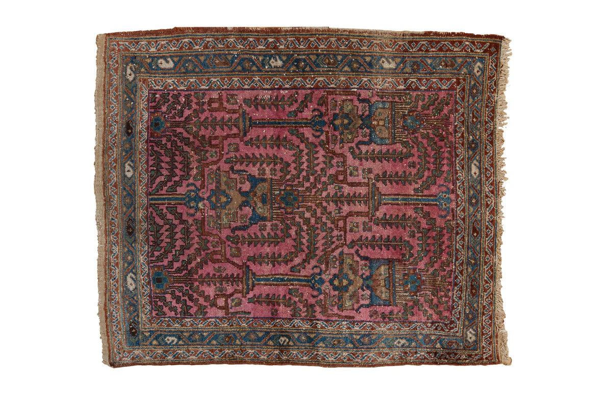 Antique Lilihan square rug, magenta field with geometric tree-of-life relief, blue-chestnut borders.