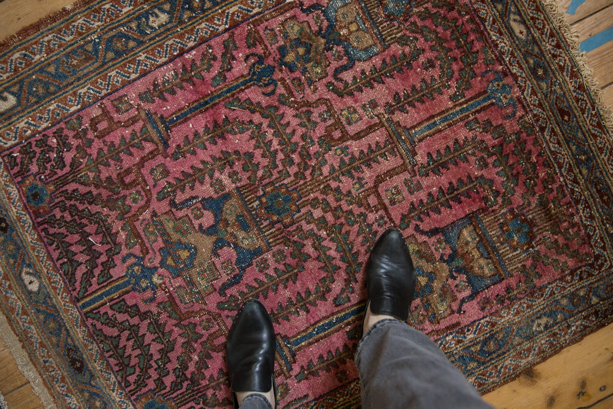 Antique Lilihan rug detail: magenta and sapphire geometric tree-of-life motifs with natural wear.