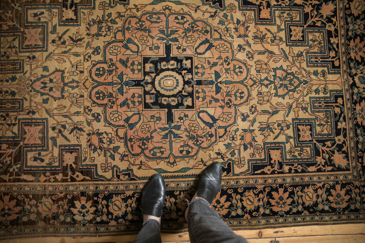 Antique Farahan Sarouk rug with scrolled tendrils, stepped cloudband spandrels, blush, and navy.