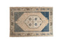 Hand-knotted vintage distressed Oushak rug with faded beige medallion and muted blue-grey field.