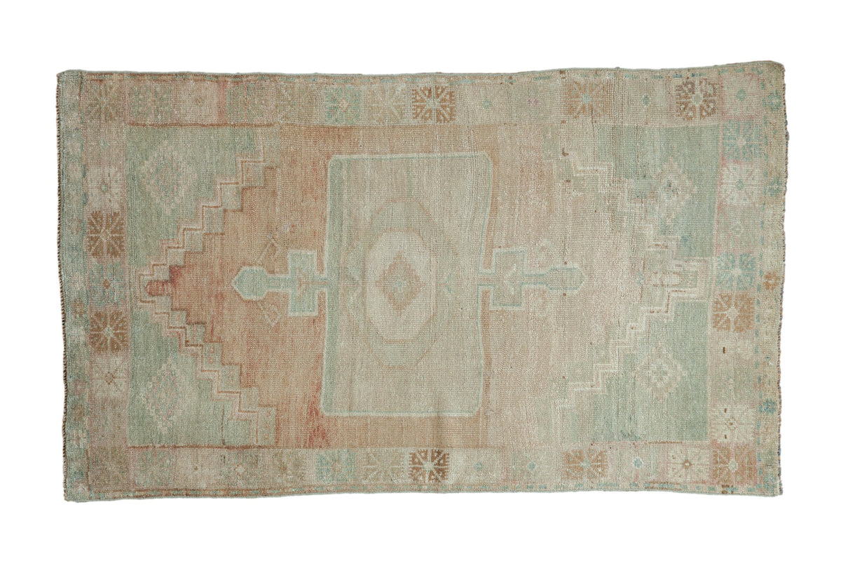 Distressed Oushak rug featuring a rectangular medallion, pale green and beige abrashed field, 3'2" x 5'4".