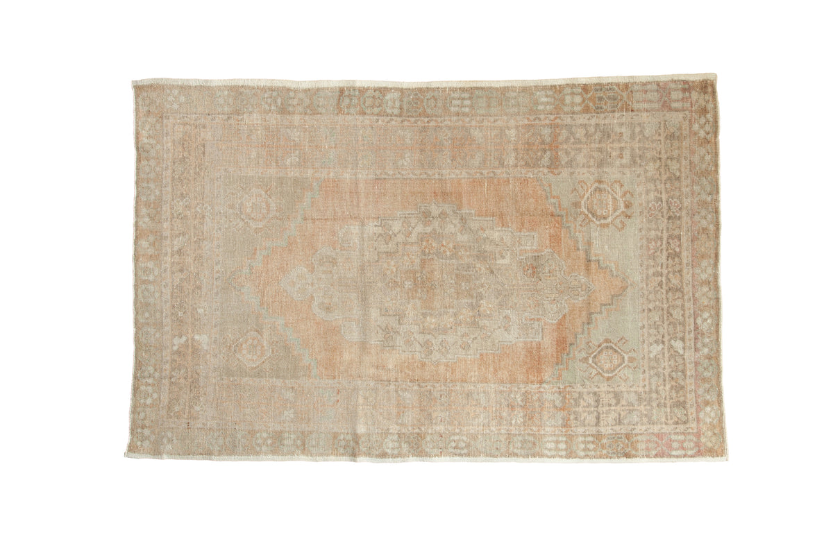 Distressed Vintage Oushak rug with elongated terra cotta medallion and soft neutral field, 4x6 feet.