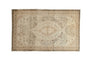 Vintage distressed Oushak rug, ivory field, coffee brown floral medallions, unique worn patina.