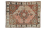 Vintage distressed Oushak rug with blush and copper tones, diamond medallion, and serrated motifs.