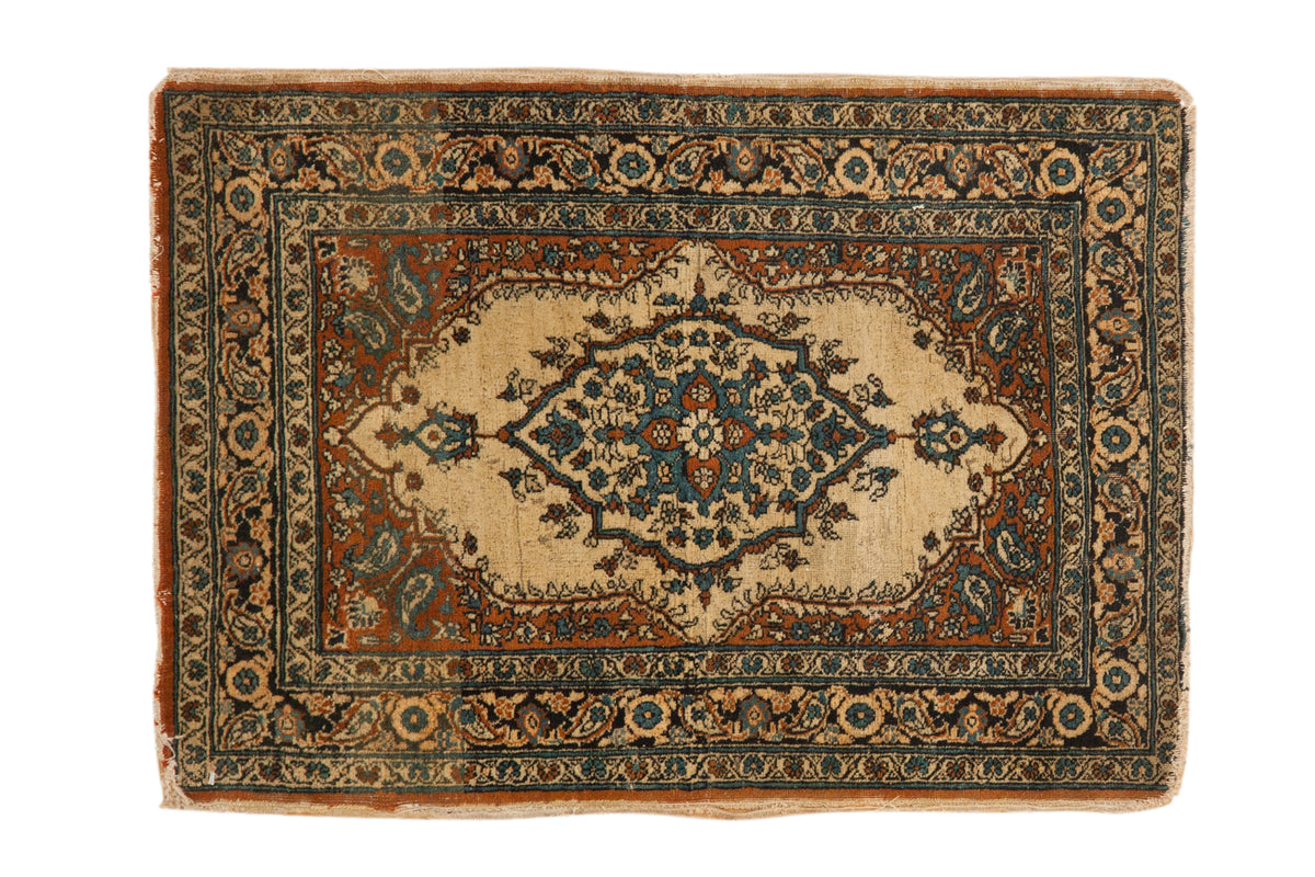 Antique Persian Tabriz rug mat with ivory ground, central medallion, rust and blue floral design.