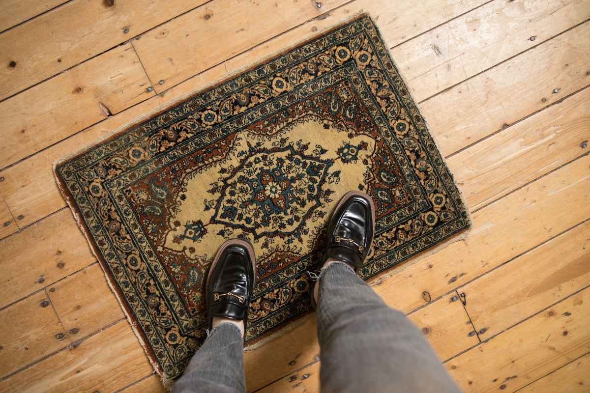 Fine antique Tabriz rug mat: ivory, rust, teal floral medallion, visible wear, tattered edges.